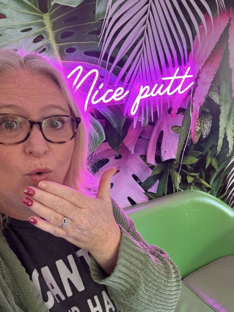 A playful neon sign reading 'Nice Putt' at the Putter Pub in Carolina Beach, near Kure Beach, NC, with tropical-themed decor.